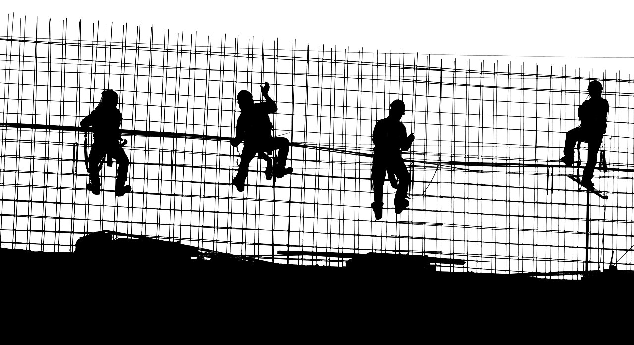 Construction workers on a steel reinforcement structure